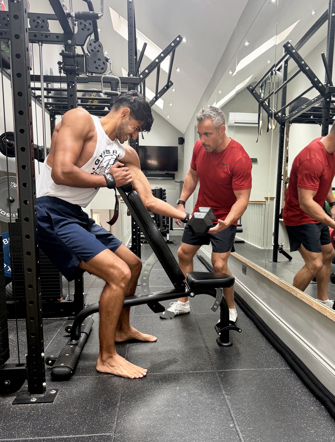 Kierin giving a client individual guidance during a dumbbell exercise